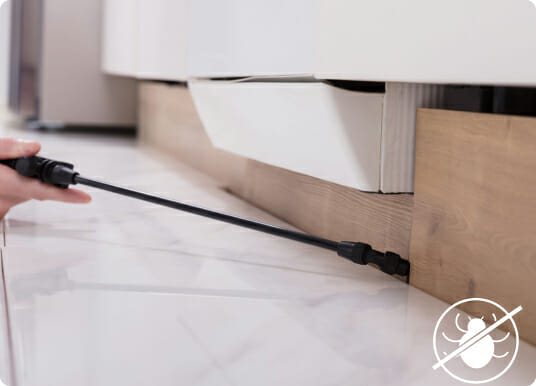 Person using black cable to connect white printer on wooden desk setup