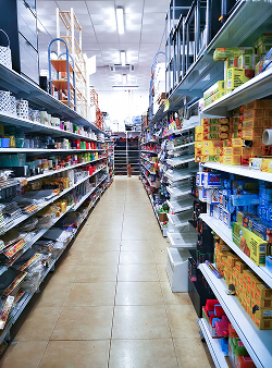 Well-stocked supermarket aisle with various products on shelves